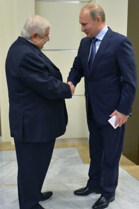 Russian President Vladimir Putin, greets Syrian Foreign Minister Walid al-Moallem in Sochi.