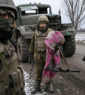 A Ukrainian serviceman retreating from Debaltseve carries his bedding near Artemivsk.