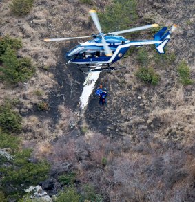 Rescue workers being rappelled from an helicopter on the crash site near Seyne-les-Alpes, French Alps on Wednesday, March 25, 2015.