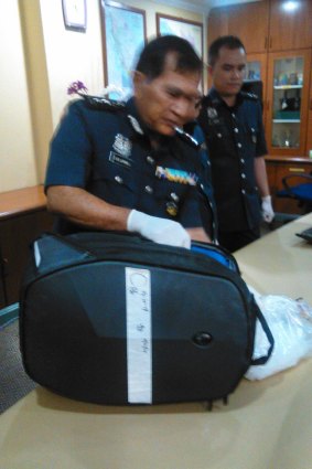Omar Thik Lim, director of Customs at Malaysia's international airport, shows the bag allegedly containing drugs that was being carried by Maria Elvira Pinto Exposto when she was arrested on December 7, 2014.