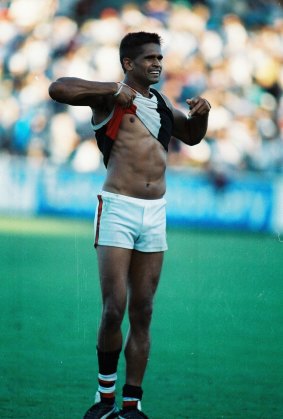Nicky Winmar raises his jumper in response to racial taunts from Collingwood fans at Victoria Park on 17 April, 1993.