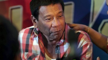 Rodrigo Duterte speaks to members of the media during a news conference after casting his vote.