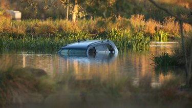 The car in which three children died is still submerged in a lake in Wyndham Vale on Thursday morning.