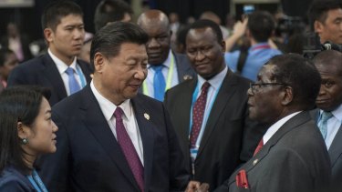 Chinese President Xi Jinping talks with Zimbabwean President Robert Mugabe in Johannesburg, South Africa in December.