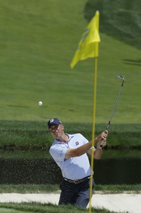 Leader: Matt Kuchar hits out of the bunker on the ninth hole.