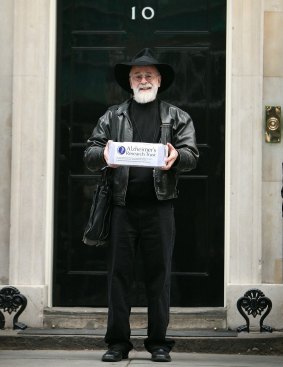 Pratchett outside No. 10 Downing Street, London, in 2008. He was handing in a petition calling for an increase in government funding for dementia research.