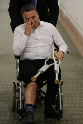 Jamie Briggs, who arrived at Parliament in a wheelchair the day after the spill, denies his injury was the result of any tangle with the table.