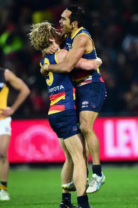 Crows Rory Sloane and Eddie Betts celebrate a goal.