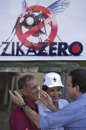 Brazilian President Dilma Rousseff, centre, and Rio de Janeiro mayor Eduardo Paes, right, talk to a resident during the launch of the Zero Zika national campaign against the Aedes aegypti mosquito in Rio de Janeiro on Saturday.