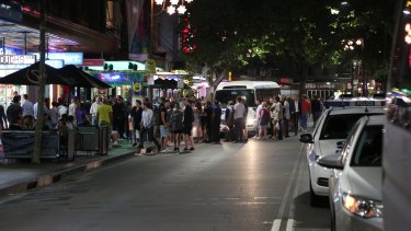 Revellers look on as police carry out the raids.