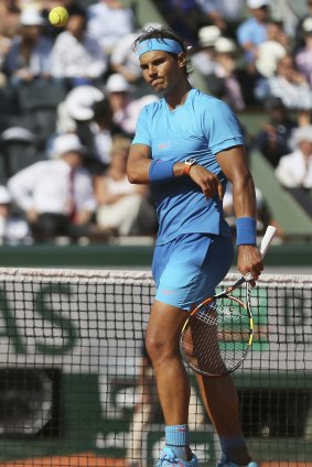 Nada: Rafael Nadal throws a ball to a ball-boy after missing a shot.