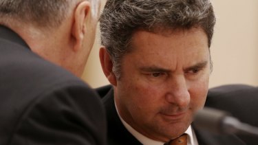 Larry Marshall, chief executive of CSIRO, confers with deputy Craig Roy at one of the Senate committee hearings in April.