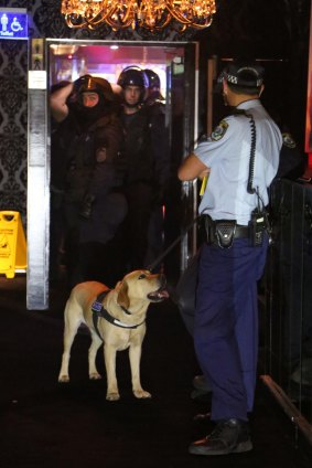 A police tactical operations unit inside the Dollhouse strip club during the raid.