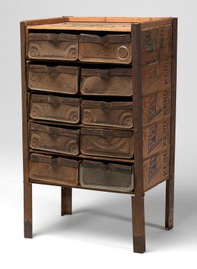 A chest of drawers constructed from recycled four-gallon kerosene drums and Vacuum Oil Company crates. 