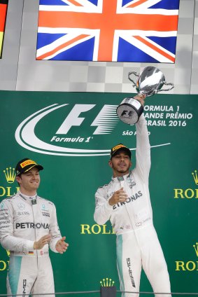One battle left: Hamilton celebrates as Nico Rosberg applauds his teammate.