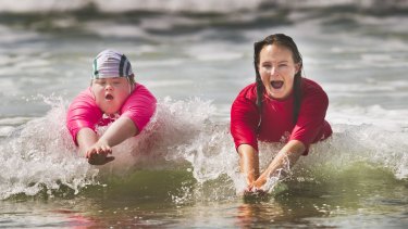 Georgia Brown, 12, is part of the Starfish Nippers program at the Anglesea Surf Club. She is photographed with her trainer Greta Dickson learning how to swim in the surf.