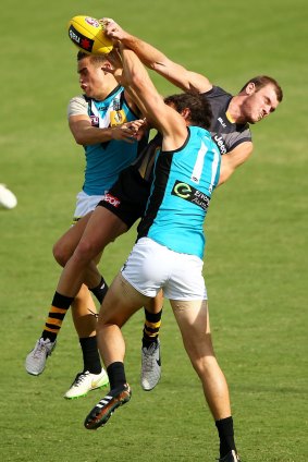 Two against one: Tiger Kamdyn McIntosh contest a mark against a pair of Port Adelaide opponents. 