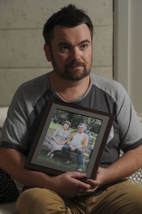 John Mikita in his Gungahlin home with a picture of his treasured grandparents.
