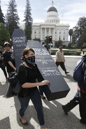 Protesters carry a "coffin" bearing the name of Michael Brown at a demonstration outside the Capitol in Sacramento, California.