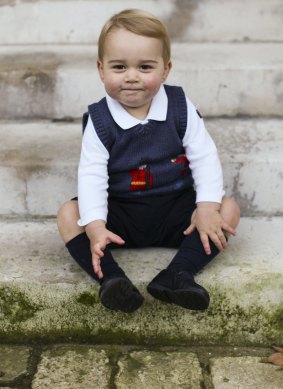 Prince George sits for his official Christmas picture in a courtyard at Kensington Palace in London, England.