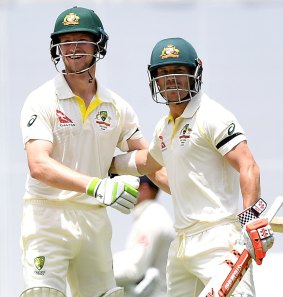 Australian batsmen Cameron Bancroft  and David Warner celebrate the win at the Gabba.