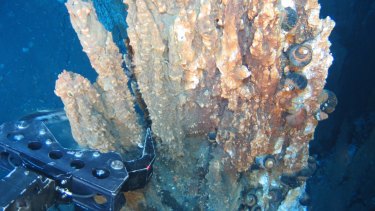 A remotely operated robotic arm breaks away part of a mineral rich "chimney" from a hydrothermal vent in prospecting in the Bismarck Sea, off PNG. Early life might have started somewhere like this.  
