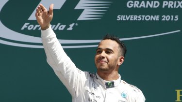Lewis Hamilton celebrates his win on the podium.