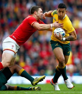 Australia's Israel Folau tries to make a break as he is tackled by George North.