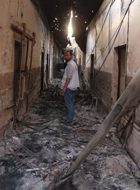An MSF employee walks inside the remains of the Kunduz hospital.