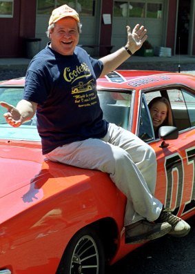 Actor Ben Jones, one of the stars of the show, sits on one of the hotrods, named the General Lee, used in the show "Dukes of Hazzard" in this 1999 photo.