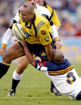 George Gregan attempts to tackle Jonah Lomu in Canberra in 2002.