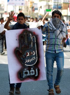 Yemeni protesters hold a banner during a demonstration against the presence of militias in the capital and attacks by al-Qaeda.