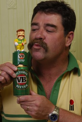 David Boon kissing figurine of himself on the top of a VB can of beer.