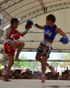 Women compete at Muay Thai, a highly combative form of kickboxing.