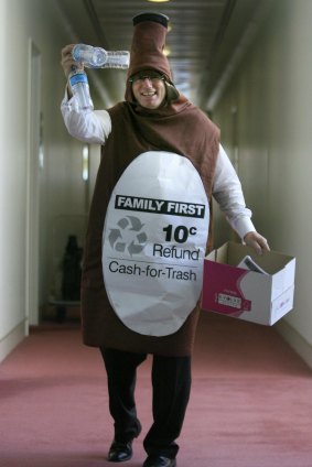 Senator Steve Fielding spruiks his concept to fund a refund scheme for recycling wearing a bottle costume in the corridors of Federal Parliament on Thursday 13 March 2008.