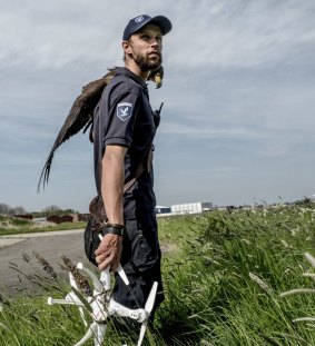 An eagle and its handler from Guard From Above, with a retrieved drone.