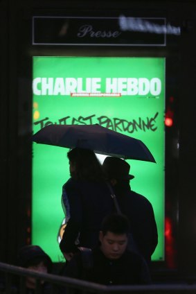 A billboard with the <i>Charlie Hebdo</i> cover in Paris.