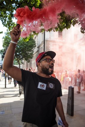 A protester holds up a flare during a demonstration.