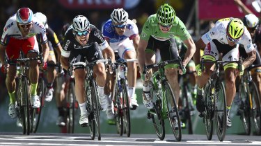 Britain's sprinter Mark Cavendish, second left, crosses the finish line in Fougeres ahead of Germany's Andre Greipel, wearing the best sprinter's green jersey, Peter Sagan of Slovakia, wearing the best young rider's white jersey.