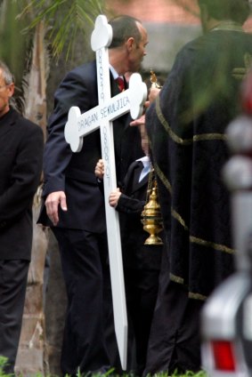 A child carries a cross at Dragan Sekuljica's funeral in 2007.