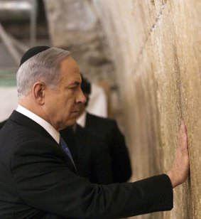 Israeli Prime Minister Benjamin Netanyahu touches the Western Wall in Jerusalem, after winning the general election on Wednesday.