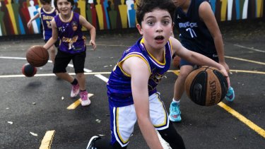 Under 12 division 2 Sydney Comets Green. For a story about how basketball is becoming the most popular sport for children. Redfern, May 10, 2022. Photo: Rhett Wyman/SMH