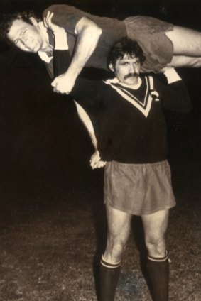Queensland prop Stan Pilecki lifts captain Mark Loan above his shoulders.