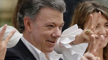 Colombia's President Juan Manuel Santos makes the victory sign after voting in a referendum in October.