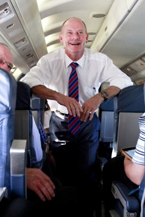Premier Campbell Newman was all smiles on a plane on day one of the election campaign.