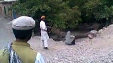 Brutality: Taliban fighters execute a woman, reputed to be the wife of one of their members, for adultery in footage from Parwan province in July 2012.