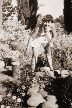 Artist Margo Lewers in her front garden. 