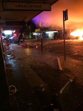 A car caught fire while shards of glass littered the street after the explosion.