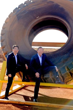Tony Abbott and Japanese Prime Minister Shinzo Abe pose for a photograph next to a haulage truck tyre during a tour of an iron ore mine in the Pilbara in July last year. Two months earlier Mr Abbott paid nearly $2500 to keep a set of bicycle wheels gifted by Mr Abe. 