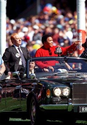 A sporting hero: Muhammad Ali does a lap of the MCG as part of the pre-match entertainment.